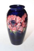 Moorcroft Pottery vase decorated with anemone on blue ground, 19cm high.