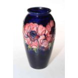 Moorcroft Pottery vase decorated with anemone on blue ground, 19cm high.