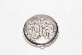 Sterling silver compact having ornate cover.