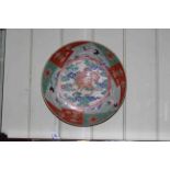 Antique Japanese charger, decorated with centre beast and flying storks on red,