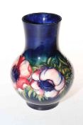 Moorcroft Pottery vase decorated with anemone on blue ground, 18cm high.