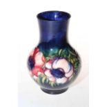 Moorcroft Pottery vase decorated with anemone on blue ground, 18cm high.