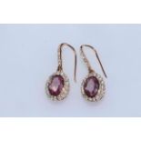 Pair of 14 carat yellow gold, pink sapphire and diamond earrings, 1.48 carat sapphires and 0.