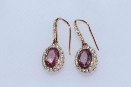 Pair of 14 carat yellow gold, pink sapphire and diamond earrings, 1.48 carat sapphires and 0.