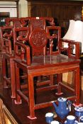 Pair carved Oriental hardwood elbow chairs.
