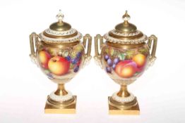Pair Royal Worcester Freeman fruit painted two handle urn vases and covers, having mask handles,