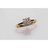 18 carat gold and nine stone diamond ring, size M/N.