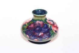 Moorcroft Pottery squat vase decorated with anemone on green ground, 8cm high.