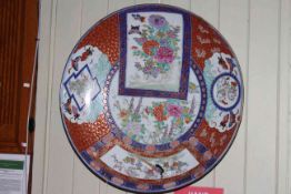 Large 19th Century Japanese charger, profusely decorated with panels of flowers,