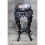 Oriental circular carved hardwood and marble inset top jardiniere stand, 68cm by 28cm diameter.