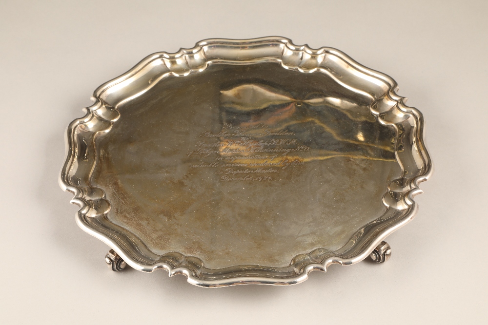 Silver salver with scallop pie crust rim, raised on four scroll feet, assay marked London 1924 by