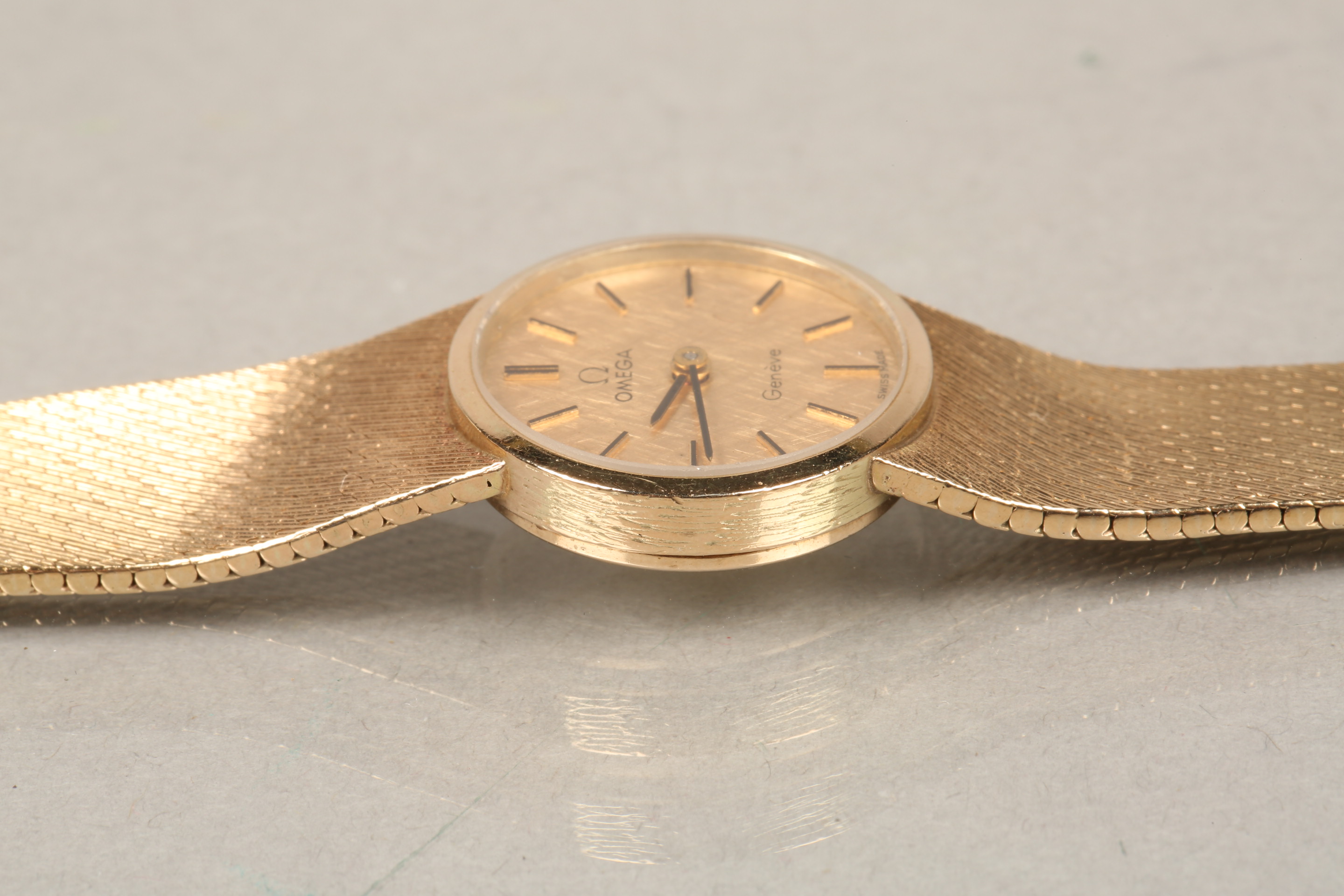 Ladies 9ct carat gold Omega wrist watch, gilt dial with gilt baton hour