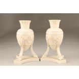 Pair of Belleek first period vases, ovoid shaped, supported on three splayed legs with hoof feet