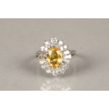 Ladies 18 carat white gold yellow sapphire and diamond cluster ring. A 2.5 carat oval shaped