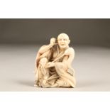 Japanese ivory okimono of a seated man, Meiji period. 8cm high