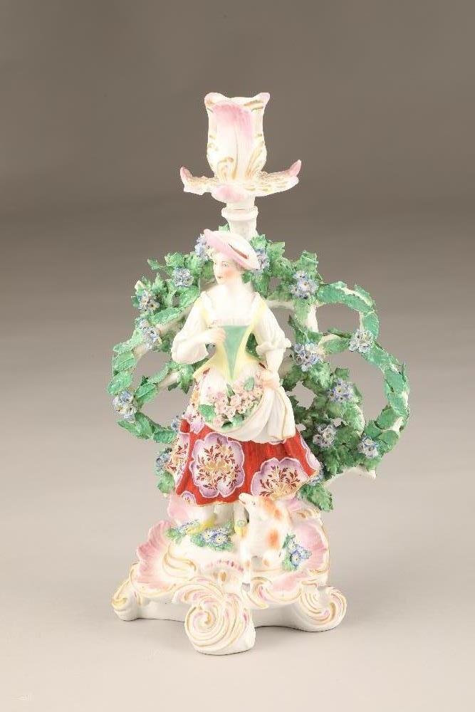 Chelsea Derby porcelain bocage figure candlestick, shepherdess with a lamb raised on a pink and gilt