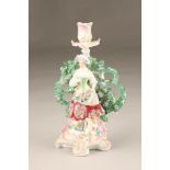 Chelsea Derby porcelain bocage figure candlestick, shepherdess with a lamb raised on a pink and gilt