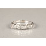 Seven stone diamond ring on white metal shank, each stone 0.07 carat, ring size Q/R