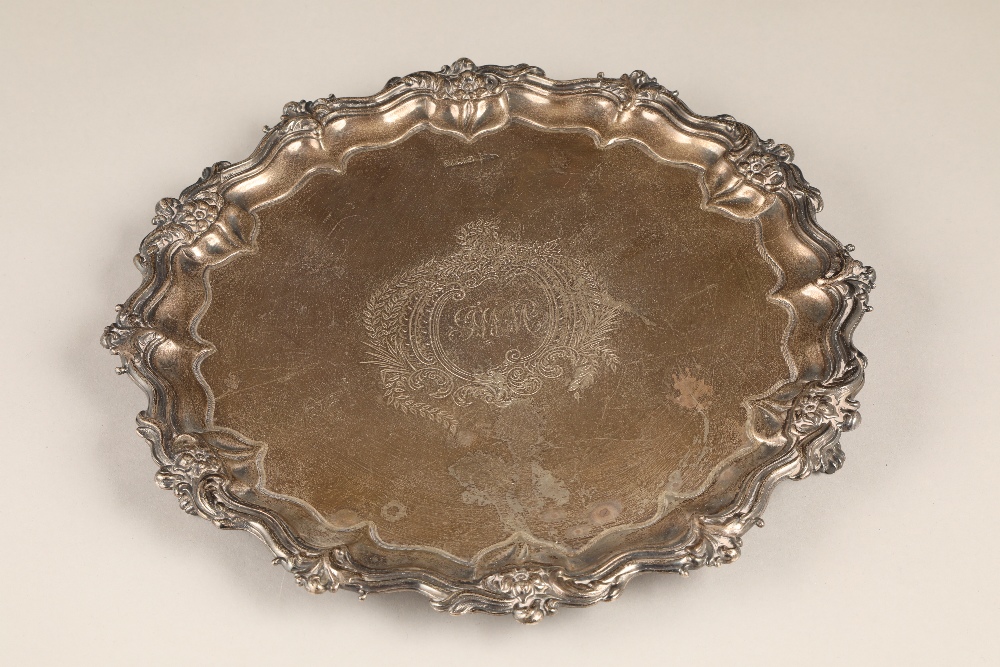 Victorian silver salver with floral border raised on three feet, by Walker & Hall.