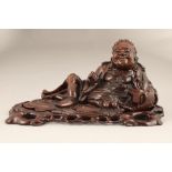 Late 19th/20th century carved hardwood figure of Liu Hai with his legendary three legged toad on a