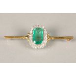 Emerald and diamond bar brooch, cushion cut emerald approximately 4 carats surrounded by twenty