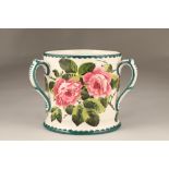 Large Scottish Wemyss ware pottery loving cup with three scroll handles, painted with cabbage roses,