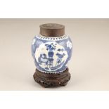 Chinese blue and white ginger jar and hardwood cover, blue ground decorated with prunus flowers, and