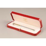 Must de Cartier silver and gilt biro pen, boxed in a presentation case with guarantee card and