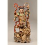 19th century Chinese painted carved wooden figure, standing on a dragon. 39cm high