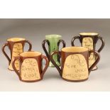 Five assorted pieces of Cumnock pottery including a three handled loving cup, two handled loving cup