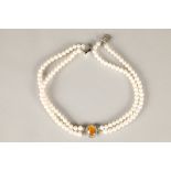 Ladies double strand cultured pearl choker, with a central oval citrine surrounded by cubic
