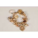 Ladies gold charm bracelet on a 14ct yellow gold chain with seventeen assorted charms: Four 9