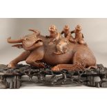 Japanese Meiji period carved hardwood figure of a water buffalo with three children riding on its