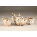 Victorian three piece silver tea service, with embossed scroll decoration, engraved monogram,