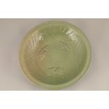 Late 19th century Chinese Celadon bowl, interior decorated with stylised waves and three fish,