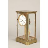 Brass four glass mantle clock, with white enamelled dial with Roman numerals. 30cm high