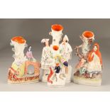 Four assorted Staffordshire pottery flat backed figure spill vases, largest 29cm high