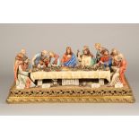 A large Capodimonte ceramic figure group of the last supper on a gilt base. 86cm x 41cm