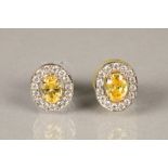 Pair of ladies oval citrine and cubic zirconia earrings, claw set in white gold. Citrine measures