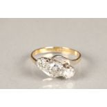 Ladies 18 carat gold three stone diamond crossover ring, the central set 0.75 carat brilliant cut