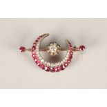 Ladies diamond and ruby crescent brooch, the crescent made up of a double row, the outer row with