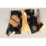 Japanese black and gold silk kimono, together with a pair of wooden Zori sandals and a floral