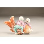 20th century Chinese porcelain figure group of two boys playing with a giant carp. 7cm high