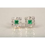 Pair of diamond and emerald earrings, central emerald surrounded by brilliant cut diamonds.