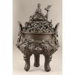 A large Chinese bronze censor, the base decorated with applied carp, flowers, seashells, with twin
