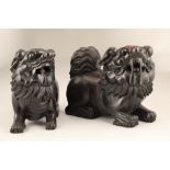 Late 19th/early 20th century pair of carved hardwood Chinese lion dogs. 31cm long, 14cm wide, 25.5cm