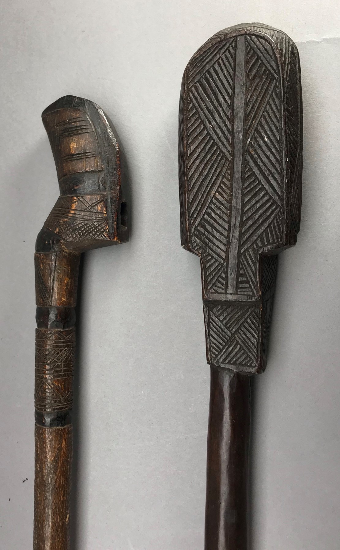 **A CARVED AUSTRALASIAN CLUB AND A CARVED AXE HAFT, LATE 19TH/20TH CENTURY