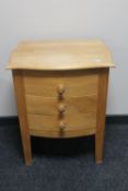 A pine shape fronted three drawer chest