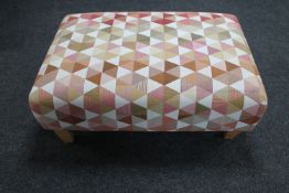 A contemporary oversized multicoloured footstool