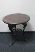 A circular cast iron Britannia bar table